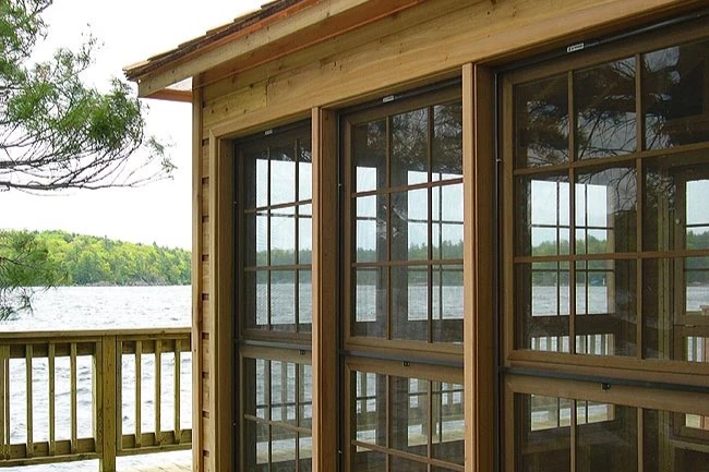 View through the glass windows of the affordable and low cost wooden cabin kit. This wooden cabin kit manufactured by cabana village.