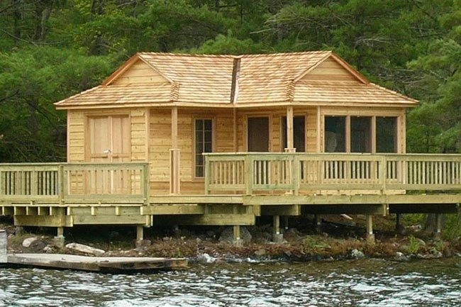 Affordable and low cost wooden cabin kit located by the lake. This wooden cabin kit manufactured by cabana village.